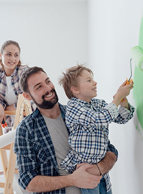 Man holding child painting